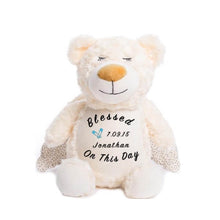 Load image into Gallery viewer, Cream colored teddy bear with shimmer wings, closed eyes, calm smile, and &quot;Blessed On This Day&quot;, a child&#39;s name and birthdate, and a pair of light blue diaper safety pins on belly
