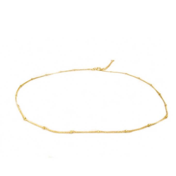 Gold thin chain choker with small gold beads spaced out and lobster claw clasp.