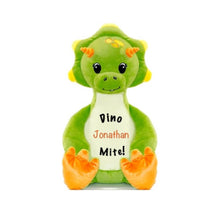 Load image into Gallery viewer, Light green triceratops dinosaur sitting upright with orange horns and feet pads, eyelashed eyes, baby tooth smile, &quot;Dinomite!&quot; in black text, and a child&#39;s name in orange text on white belly.
