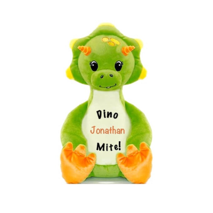 Light green triceratops dinosaur sitting upright with orange horns and feet pads, eyelashed eyes, baby tooth smile, 