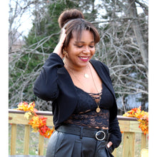 Load image into Gallery viewer, slight side view of cropped blazer jacket with lace cami and vegan leather pleated pants
