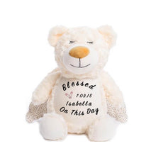 Load image into Gallery viewer, Cream colored teddy bear with shimmer wings, closed eyes, calm smile, and &quot;Blessed On This Day&quot;, a child&#39;s name and birthdate, and a pair of pink diaper safety pins on belly
