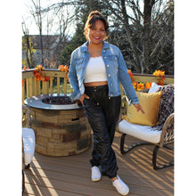 Load image into Gallery viewer, front view of black faux leather joggers with front design bow and 2 side pockets
