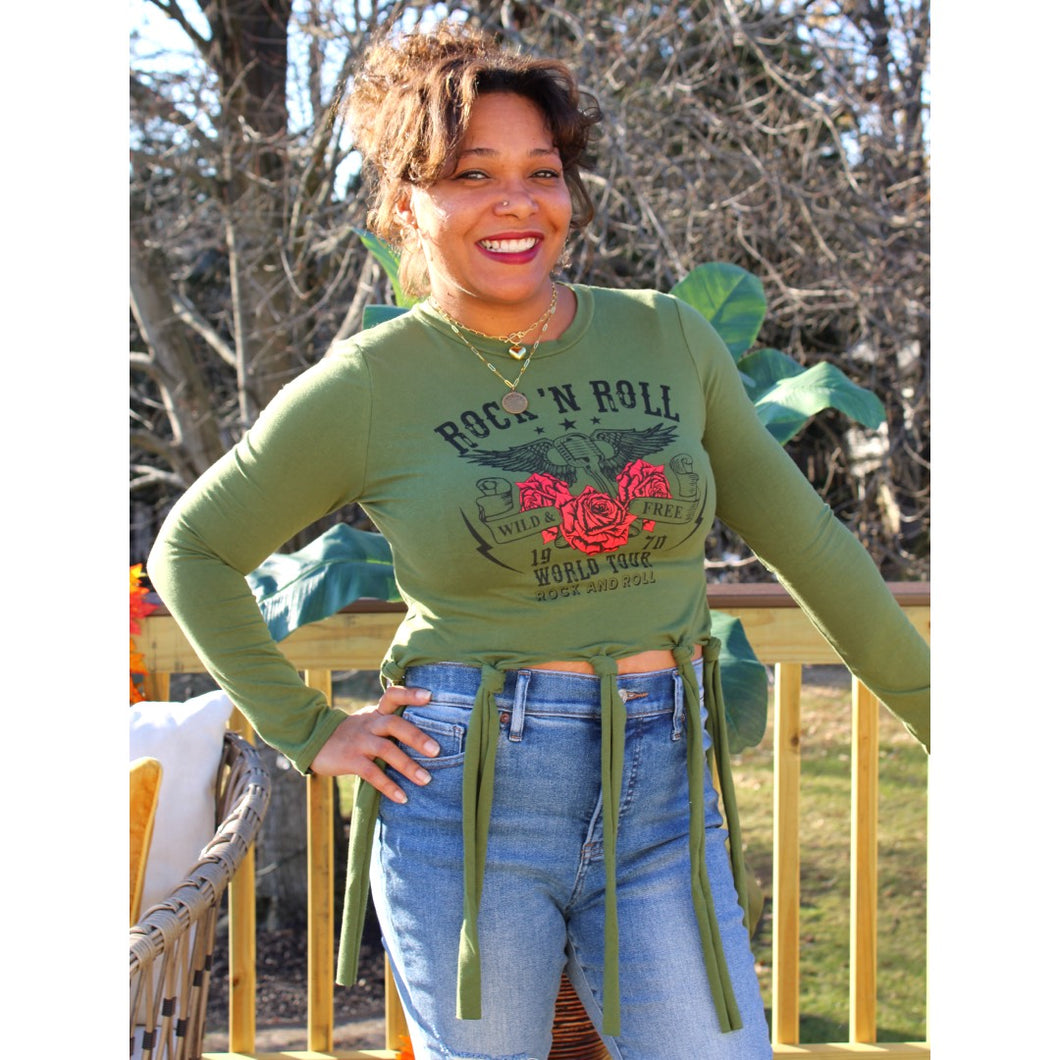 Front view of fringe tie over crop top with rock N' roll design and light wash jeans