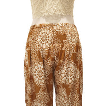 Load image into Gallery viewer, Terra-cotta brown harem pants with white boho floral print (close-up).
