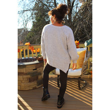 Load image into Gallery viewer, Back view of Lavender Gray sweater tunic with left side seam slit and black knee cut out leggings
