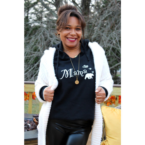 front view of mama bear pull over hoodie layered with long knitted cardigan and faux leather leggings