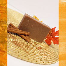 Load image into Gallery viewer, Brown colored soap bar next to cinnamon sticks.
