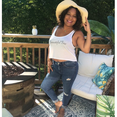 Model wearing white Beautiful Bae top with beach hat.