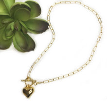 Load image into Gallery viewer, Gold chain necklace with toggle and clasp front closure and heart pendant.
