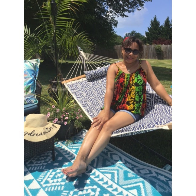 5'1 Model Wearing Floral Rasta Camisole Top With Red Flower Accessory 1